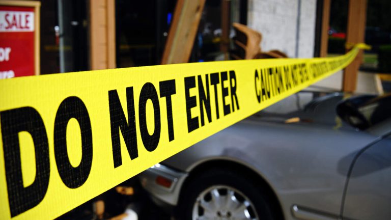 Woman Rescued From Dangling Porsche After Crashing Through Parking Garage