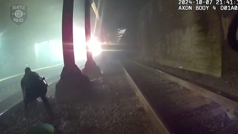 WATCH: Cop Pulls Injured Man Off Tracks Seconds Before Train Speeds Past