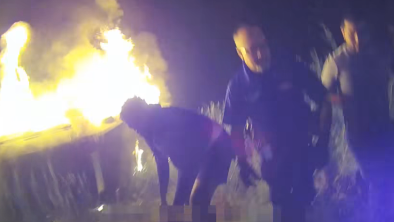 Dramatic Video Shows Motorists Help Police Rescue Woman From Burning Car